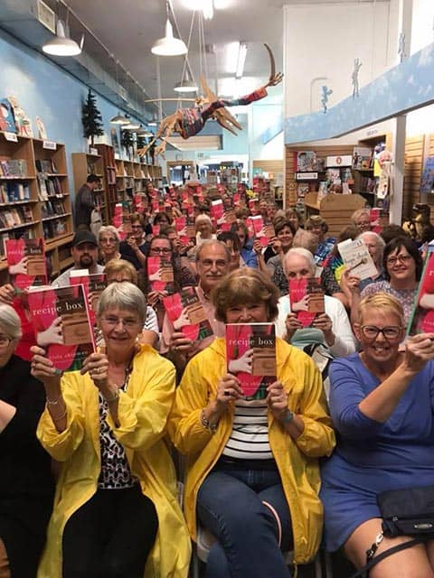 Readers at a book tour event for Wade Rouse/Viola Shipman holding up copies of THE RECIPE BOX
